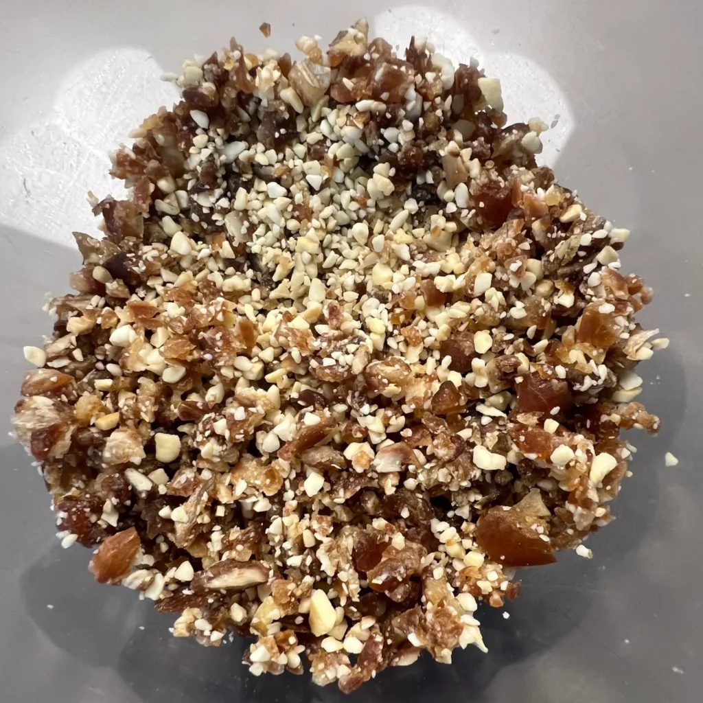 Crumbled cashew nuts and dates in a food processor.